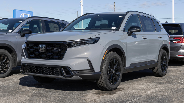 A matte gray Honda CR-V at a Honda dealership lot