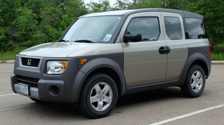 A gray Honda Element in a parking space