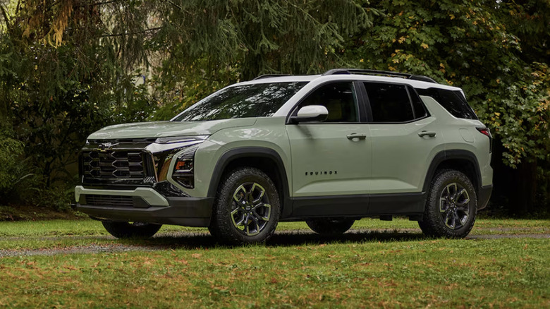 A 2025 Chevy Equinox in green sitting near some trees