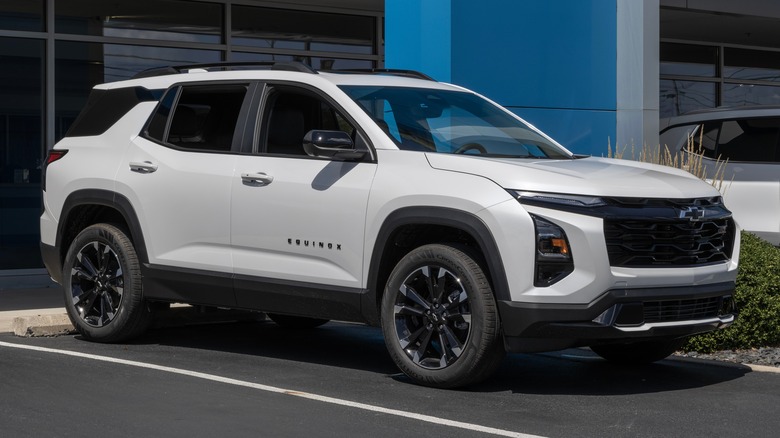 A white 2024 Chevy Equinox at a Chevy dealership