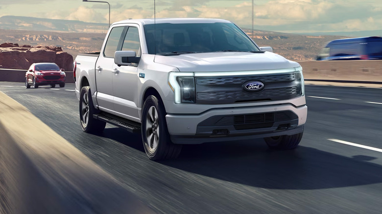 A gray Ford F-150 Lightning driving on a highway