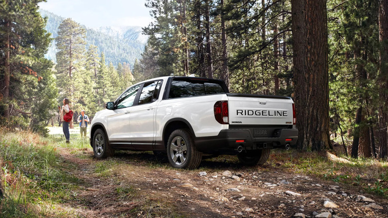 A white Honda Ridgeline parked in the forest