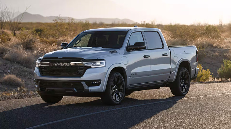 A Ram 1500 on a road at sunset