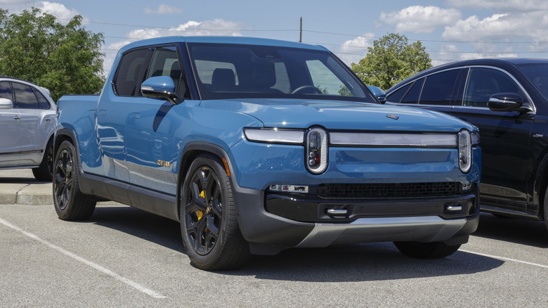 A blue Rivian R1T in a parking space