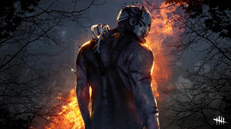 The Trapper, facing a campfire with his back to you.