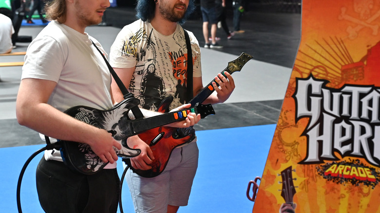 Gamers playing Guitar Hero