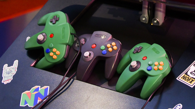 Several Nintendo 64 controllers