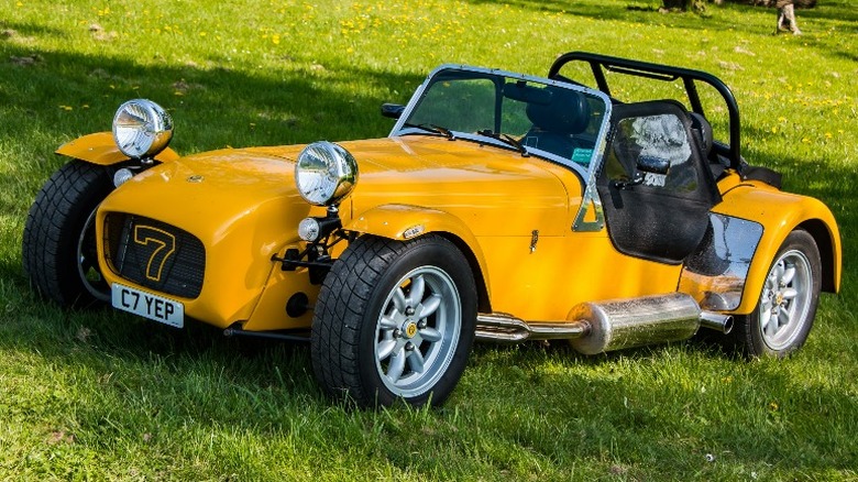 Yellow Lotus Seven parked on the grass