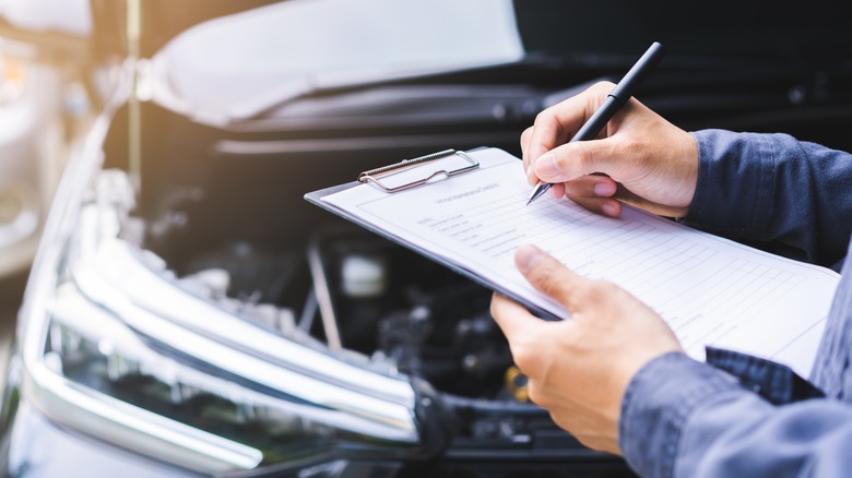 List being compiled in front of vehicle