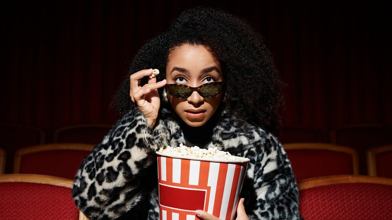 Woman with popcorn watching movie