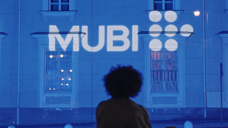 Woman looking up at Mubi logo 