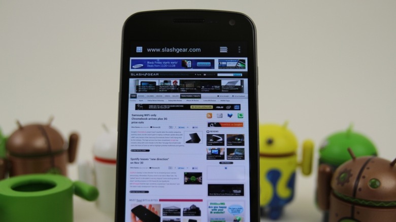 Samsung Galaxy Nexus standing next to Android logo toys