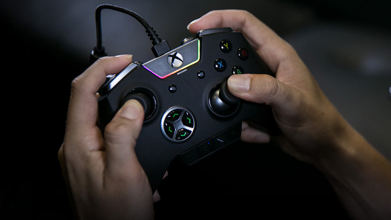 Hands gripping Razer Wolverine Ultimate controller