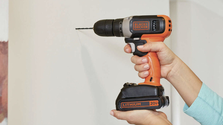 Person using Black+Decker drill