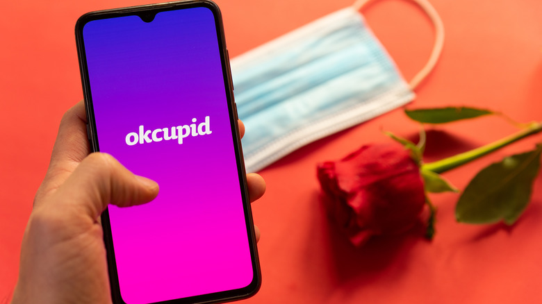 OkCupid logo on phone screen