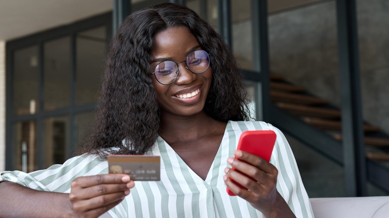 person holding phone and card