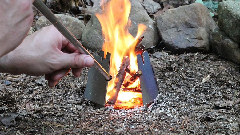 person using campfire bellow