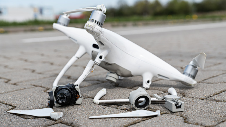 Broken drone on pavement