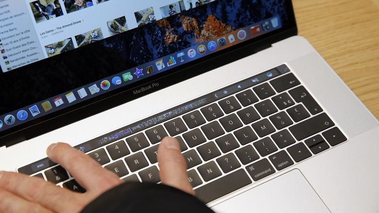 Person using Touch Bar on MacBook