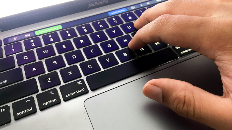 Person using Macbook with Touch Bar