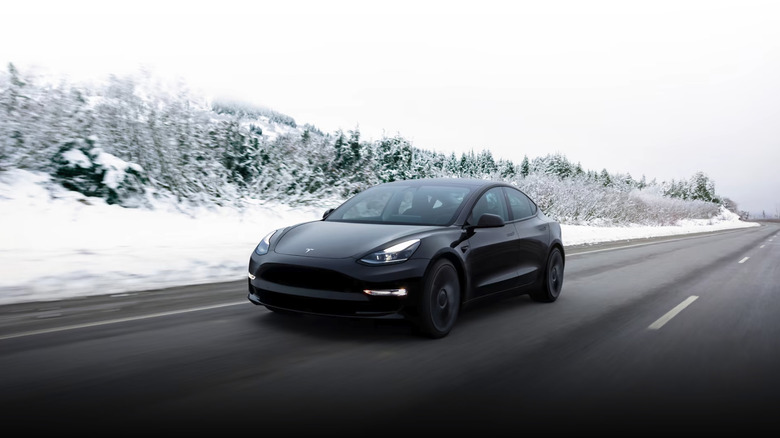 Black Tesla snowy road