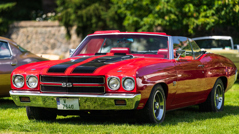 Red 1970 Chevelle parked on grass