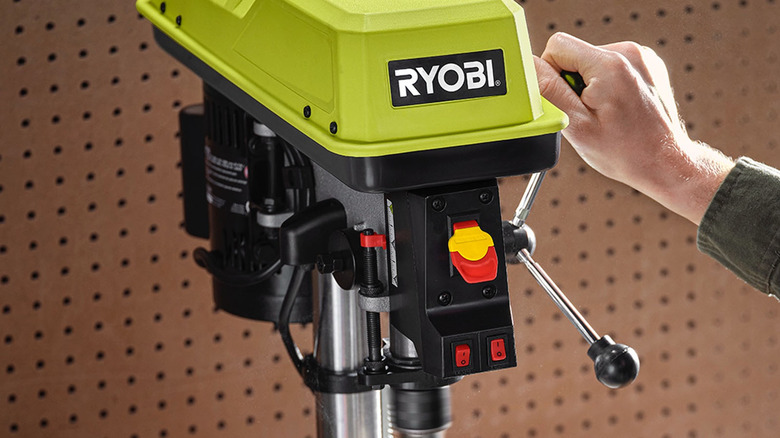 person using ryobi speed drill press