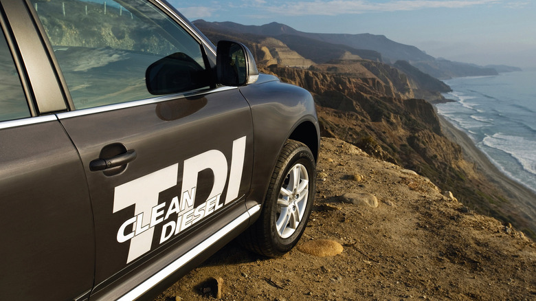 VW touareg with a TDI Clean Diesel sticker parked on a cliff overseeing the sea