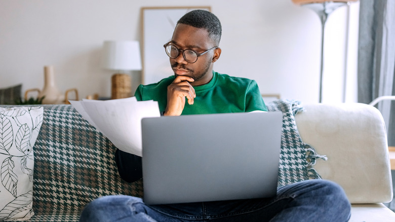 person concentrating in front of laptop