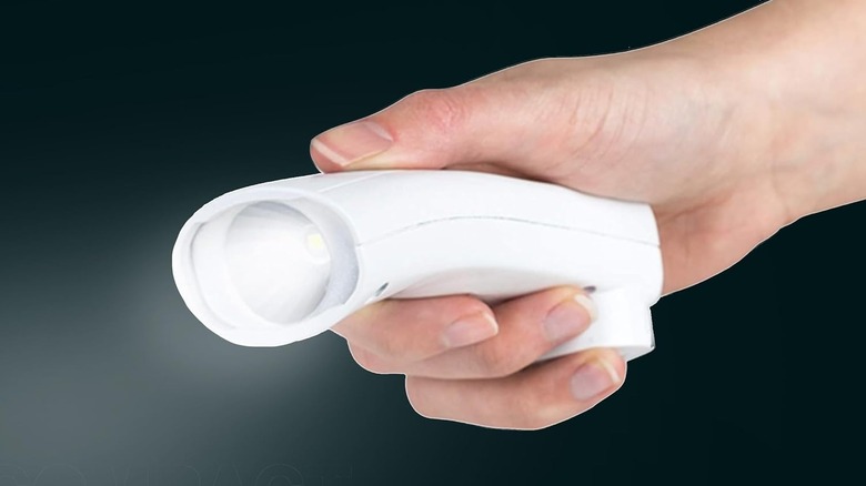 Hand holding Energizer LED Rechargeable Plug-In Flashlight