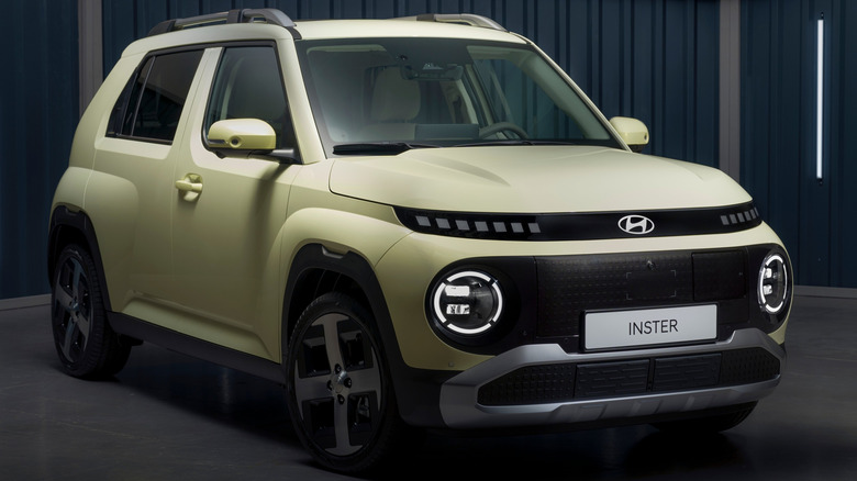 The Hyundai Inster in cream, front 3/4 view, studio shot