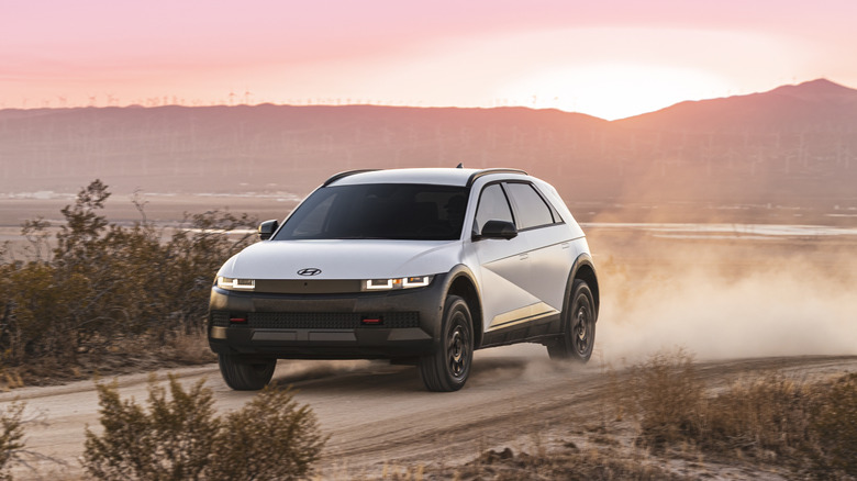 The new Hyundai Ioniq 5 XRT on a dirt trail, front 3/4 view, white exterior