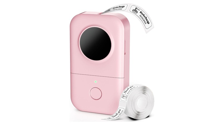 Pink rectangular electronic device with label stickers exiting the top