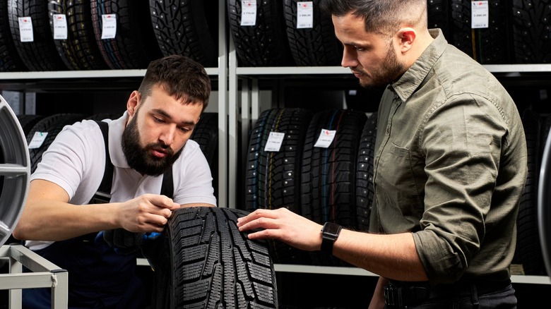 mechanics inspecting tires