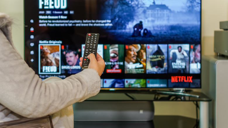 Person operating a TV.