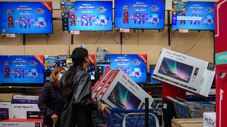 People buying TVs at a sale.