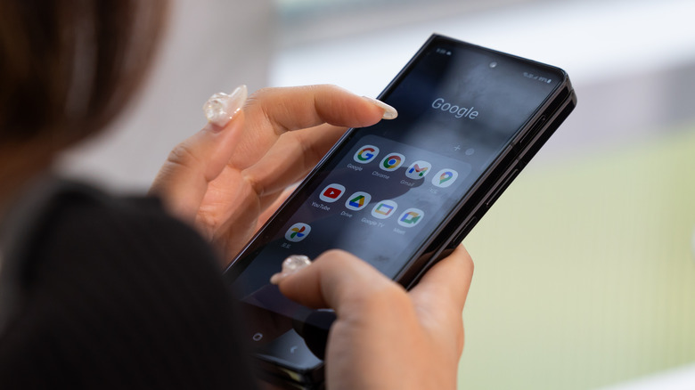 A member of media uses a Samsung Electronics Co. Galaxy Z Fold 5 smartphone