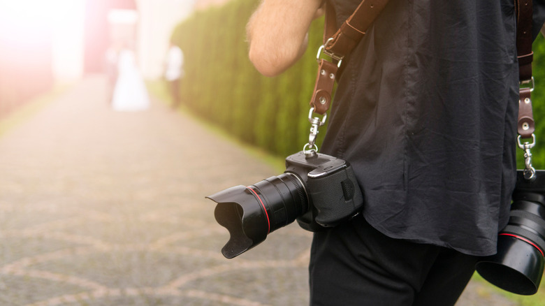 Photographer with camera holster