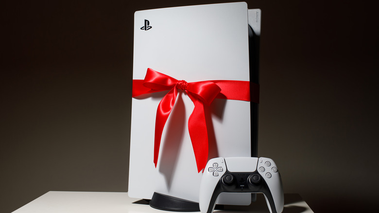 A Playstation 5 wrapped in a bow sits 