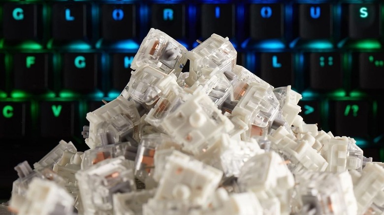 Kailh Speed Silvers piled up in front of a keyboard