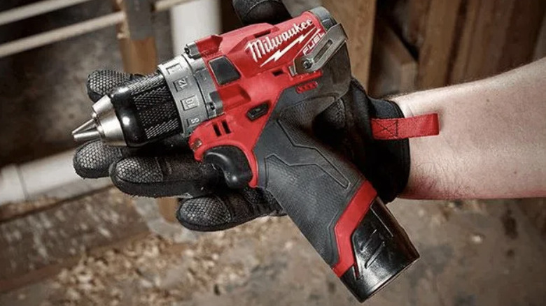 person using M12 hammer drill