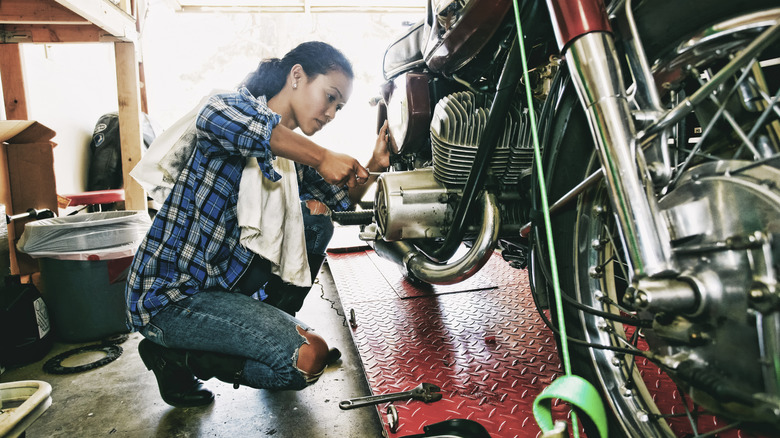 person working on motorcycle