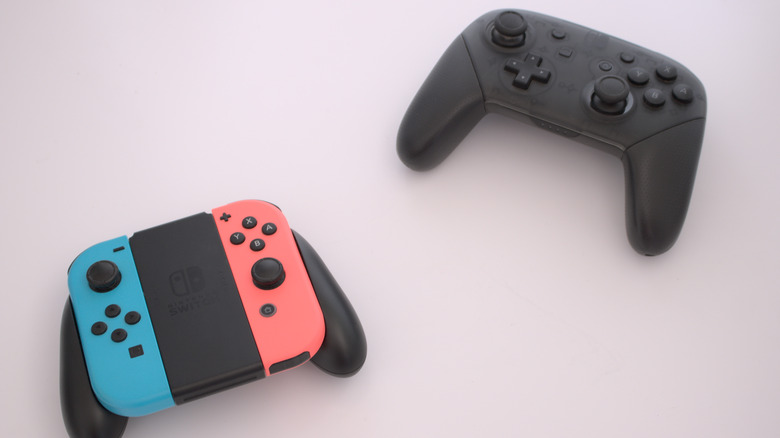 Nintendo Switch Pro controller sitting next to JoyCons.