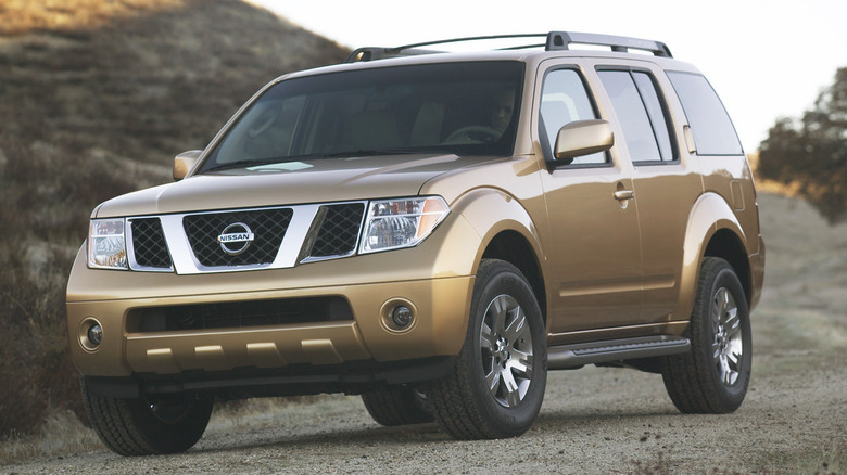 Gold 2007 Nissan Pathfinder parked on dirt