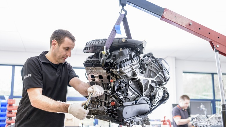 A mechanic working on a car engine