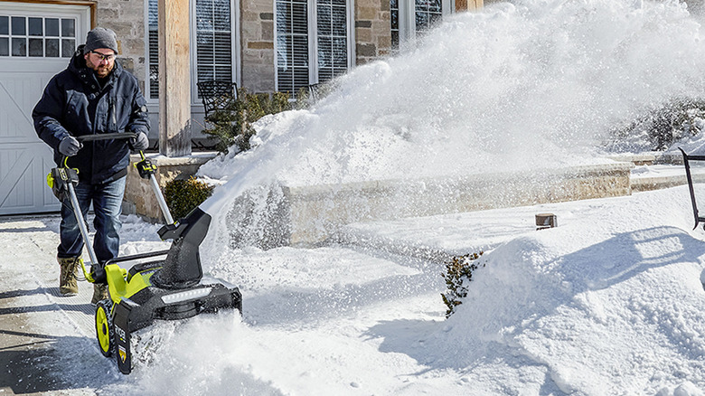 Man using RYOBI snow blower