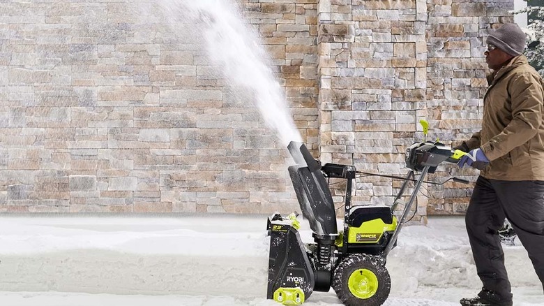 Man using snow blower