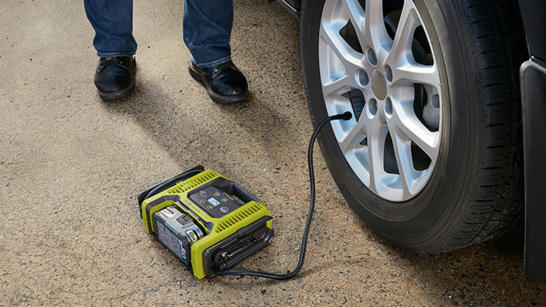 Ryobi Dual Function Inflator/Deflator inflating tire