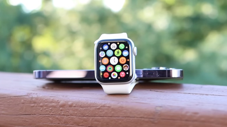 Apple Watch SE 2 held down by an iPhone