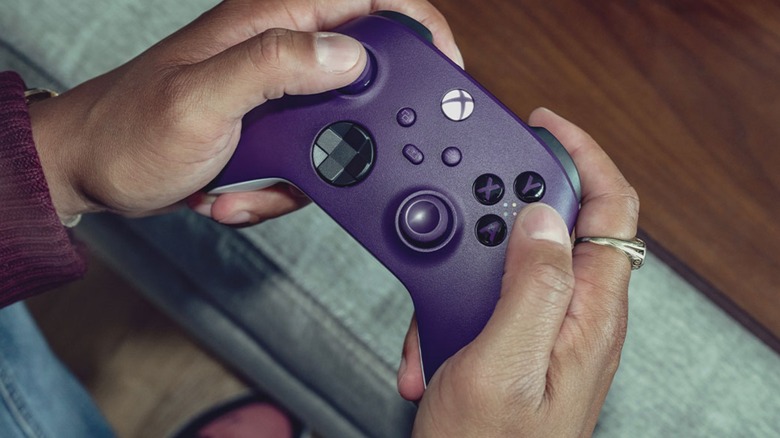 xbox purple controller holding playing